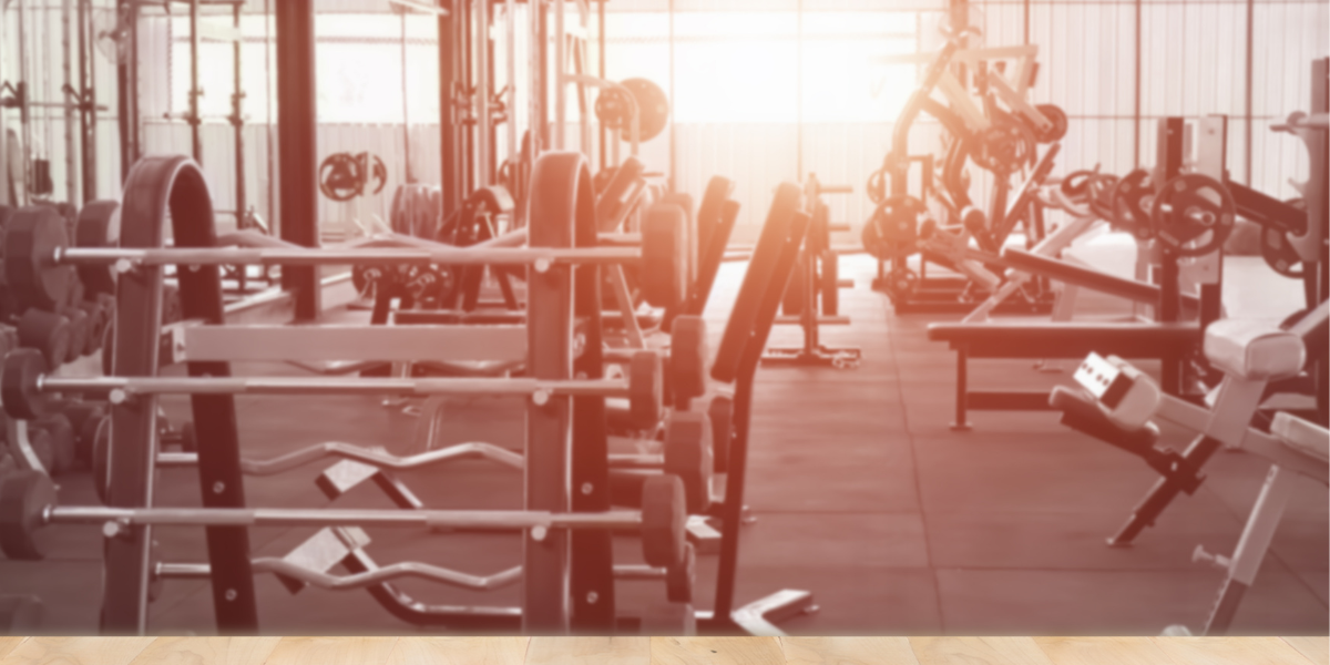 Person working out at the gym while choosing the best time for a consistent fitness routine.